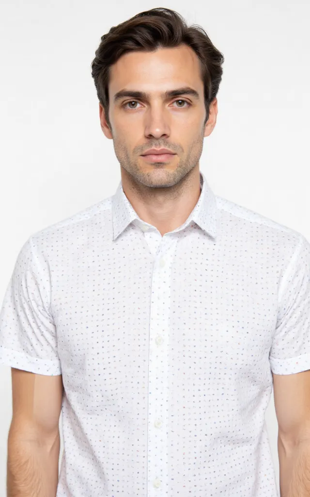 A French model wearing a Dot   and   dash pattern   printed shirt, against a white background, in a front   facing bust portrait